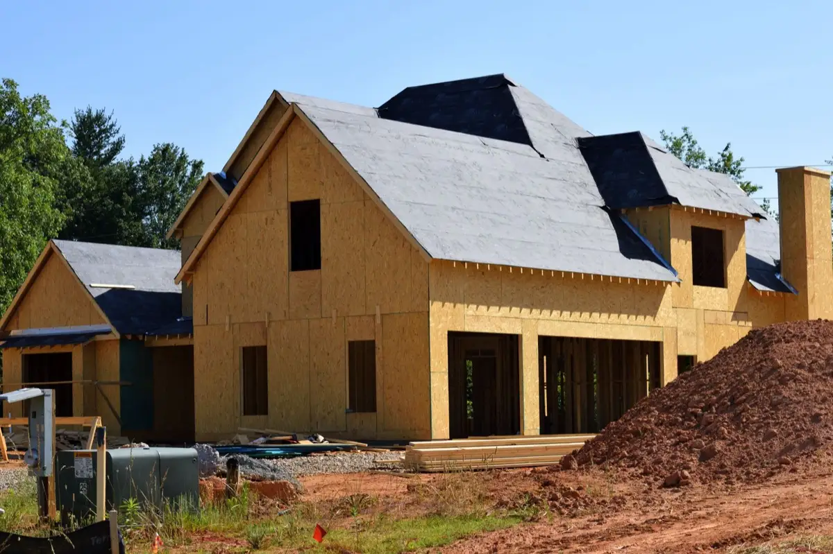 House with new roof decking and synthetic underlayment during a roof replacement in Bryan, TX